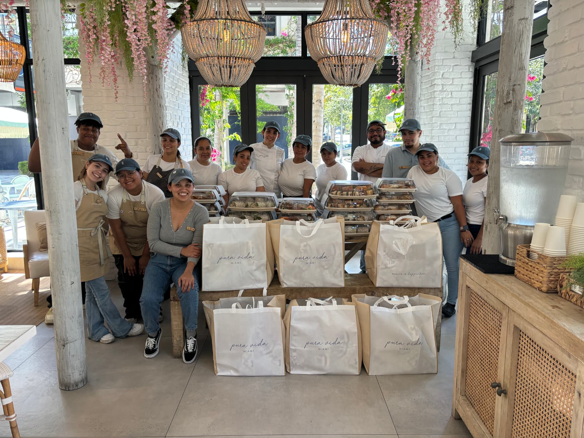 Full hospitality team gathered around a large catering order