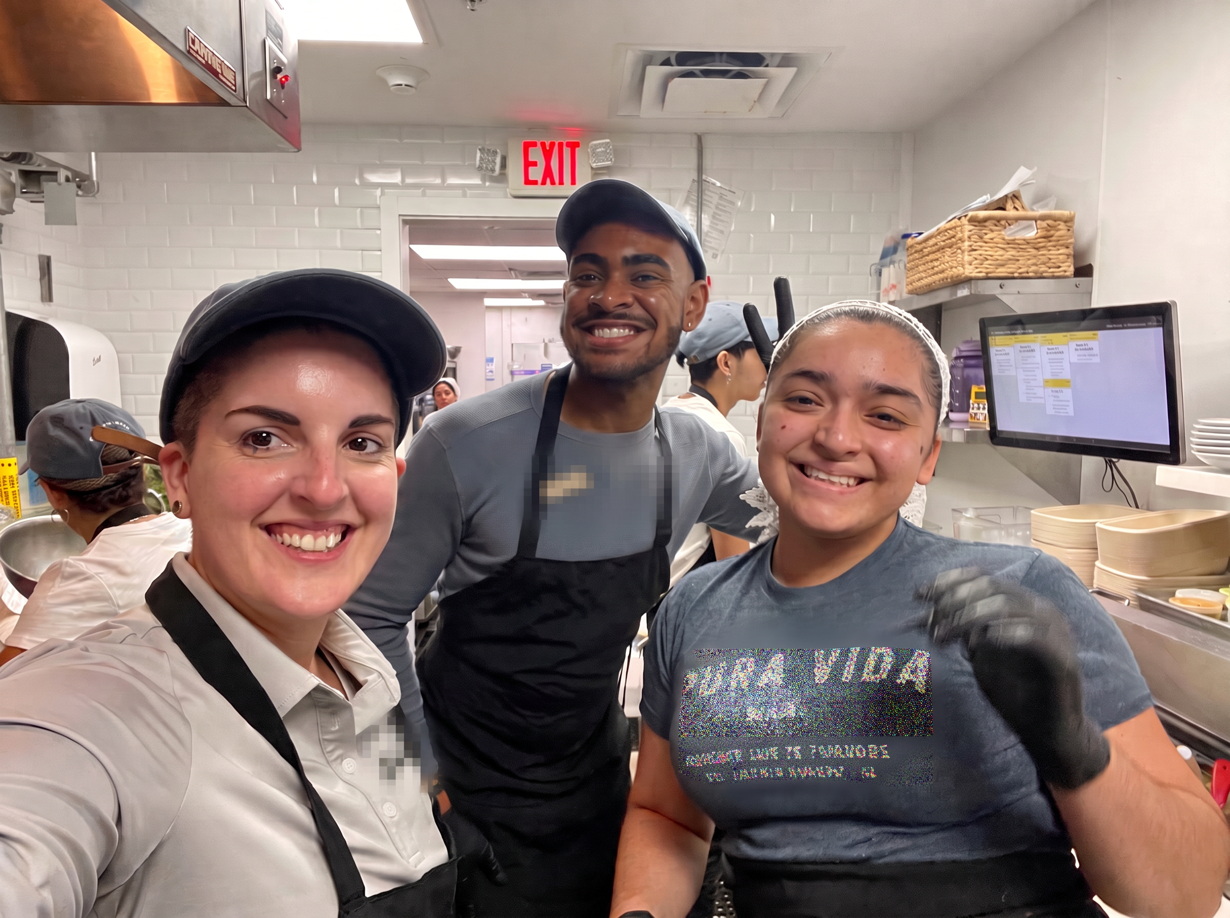 Kitchen team smiling together during service